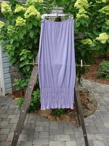 2000 NWT Rings of Saturn Skirt Unpainted Twilight Size 2 displayed on a wooden ladder, showcasing its full length, elastic waistline, and detailed smocking for versatile summer styling.