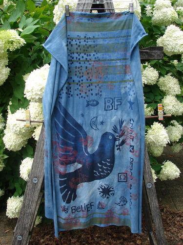 Bluefishfinder.com Barclay Scarf Wrap Belief Spirit Magic Love Dove Echo Blue OSFA, a long blue wrap with a soft drape and narrow borders, printed with a large dark dove, BF initials, stars, and layered graphic motifs. It hangs vertically against lush white hydrangeas and green foliage, with muted blue tones and a weathered, textile-rich finish.