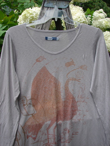 Bluefishfinder.com Barclay Modal Slub Long Sleeved A-Lined Tee in peacock grey, size 0, with a soft slub-knit texture and a V-neckline. The long sleeves and gently flared silhouette frame a faded rust-toned graphic print on the front.