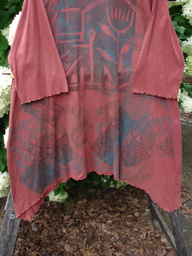Bluefishfinder.com Barclay Three Quarter Sleeve Color Wheel Tunic Tulip Dream Clay Size 1, a loose clay-pink tunic with three-quarter sleeves, scalloped hems, and a layered hand-dyed look. Dark rose and slate floral wheel motifs spread across the front and sleeves, framed by soft drape and uneven edges.