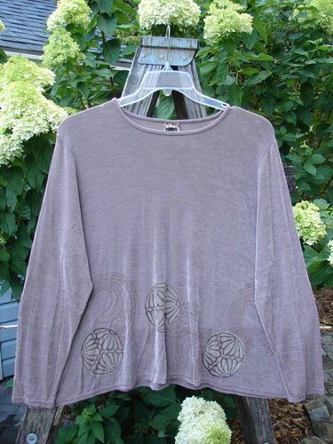 1999 Acetate Lycra Crop Top Petal Circle Purple Haze Size 1 displayed on a hanger, showcasing its long sleeves, rounded neckline, and boxy crop shape with textured ribs.