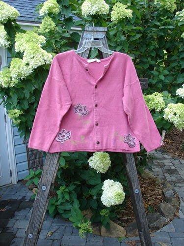 1997 Cotton Cashmere Long Sleeved Cardigan Stone Flower Geranium Altered OSFA displayed on a wooden easel, showcasing the floral design and front button detail.