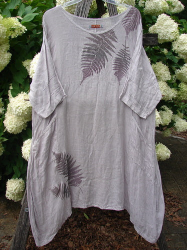 Bluefishfinder.com Barclay Linen Wave Pocket Dress in fern rice paper, size 1, is a loose linen dress with a softly draped, asymmetrical hem, wide short sleeves, and fern-like wave prints in muted gray-brown.