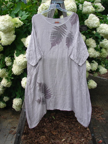 Bluefishfinder.com Barclay Linen Wave Pocket Dress in Fern Rice Paper, size 1, hangs loose and draped with a soft, crinkled linen texture. The pale rice-paper fabric is marked by fern-like wave prints in muted gray-purple, with short sleeves and a relaxed, asymmetrical hem.
