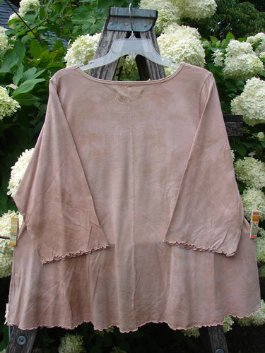 Bluefishfinder.com Barclay Three Quarter Sleeved Cafe Tee Giant Sunflower Mottled Pumpkin, a mottled pumpkin-brown top with wide three-quarter sleeves and a soft, draped silhouette, hanging against white hydrangeas and green foliage.