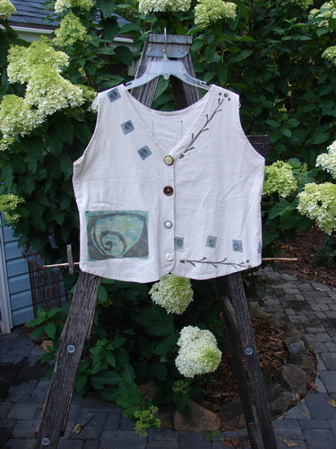 1993 The Vest Wind Twig Tea Dye Altered Size 1 displayed on a wooden stand, featuring blue designs, vintage blue fish buttons, tuxedo-style front tails, and a draw-corded back with metal grommets.