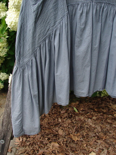 Bluefishfinder.com Barclay Gauze Batiste Summer Frock Jumper in unpainted gray day stripe, shown in a close view of the gathered skirt and sleeve. The lightweight gauze batiste drapes in soft vertical folds with a textured, airy finish.