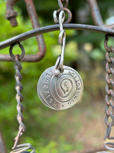 Close-up of 1995 Sterling Silver Twisty Charm Blue Fish Connection Pendant, featuring intricate metalwork, a twisty design, and a key chain attachment.