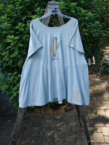 1995 Hop Scotch Dress Garden Friends Beach Glass Size 2, displayed on a ladder, showcases a vertical graphic with foliage and circular elements. The dress features a swinging A-line shape and unique garden-themed artwork.