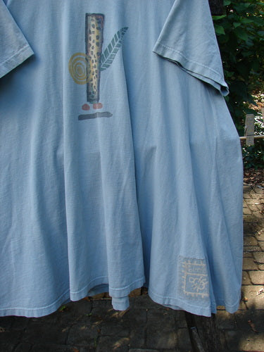 1995 Hop Scotch Dress Garden Friends Beach Glass Size 2 draped outdoors, showcasing its A-line shape, abstract front print, scooped neckline, and elastic-topped pocket, embodying BlueFishFinder's vintage creativity.