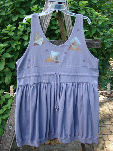 1996 Amusement Jumper Triangle Shadow Mulberry Size 1 features a sleeveless, empire-waist design with a bubble-style skirt, drawstring tie, and abstract triangle pattern. Perfect for vintage Blue Fish Clothing enthusiasts.