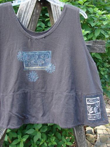 1995 Klee Top Garden Friends Shadow Size 1, a loose, sleeveless tunic with blue stencil-style prints, displayed on a wooden ladder. Features include a scooped neckline and signature Blue Fish ceramic button detailing.