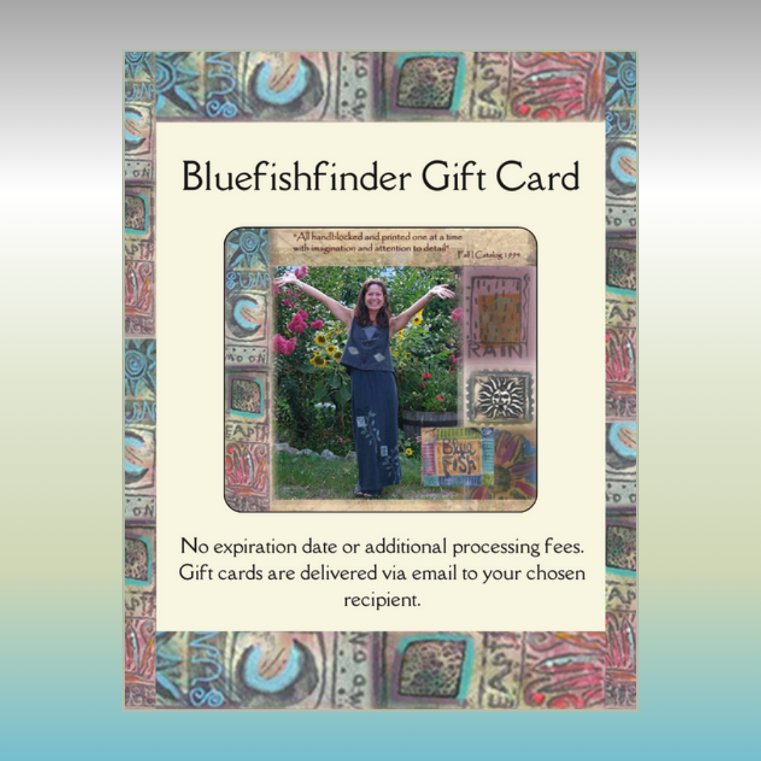 A smiling woman in a blue dress promoting the Bluefishfinder Gift Card from $25.00, perfect for gifting and redeemable online or by phone for vintage Blue Fish Clothing.