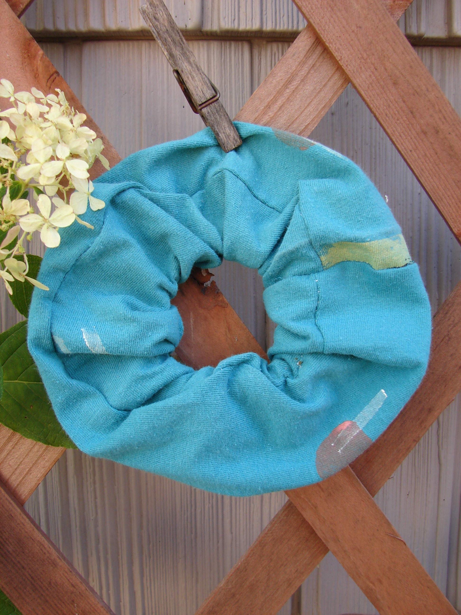 1990 PMU Cotton Hair Scrunchie Abstract Turq One Size, featuring ruffled fabric and thin elastic, displayed on a wooden surface, celebrating sustainable vintage designs from Bluefishfinder.com.