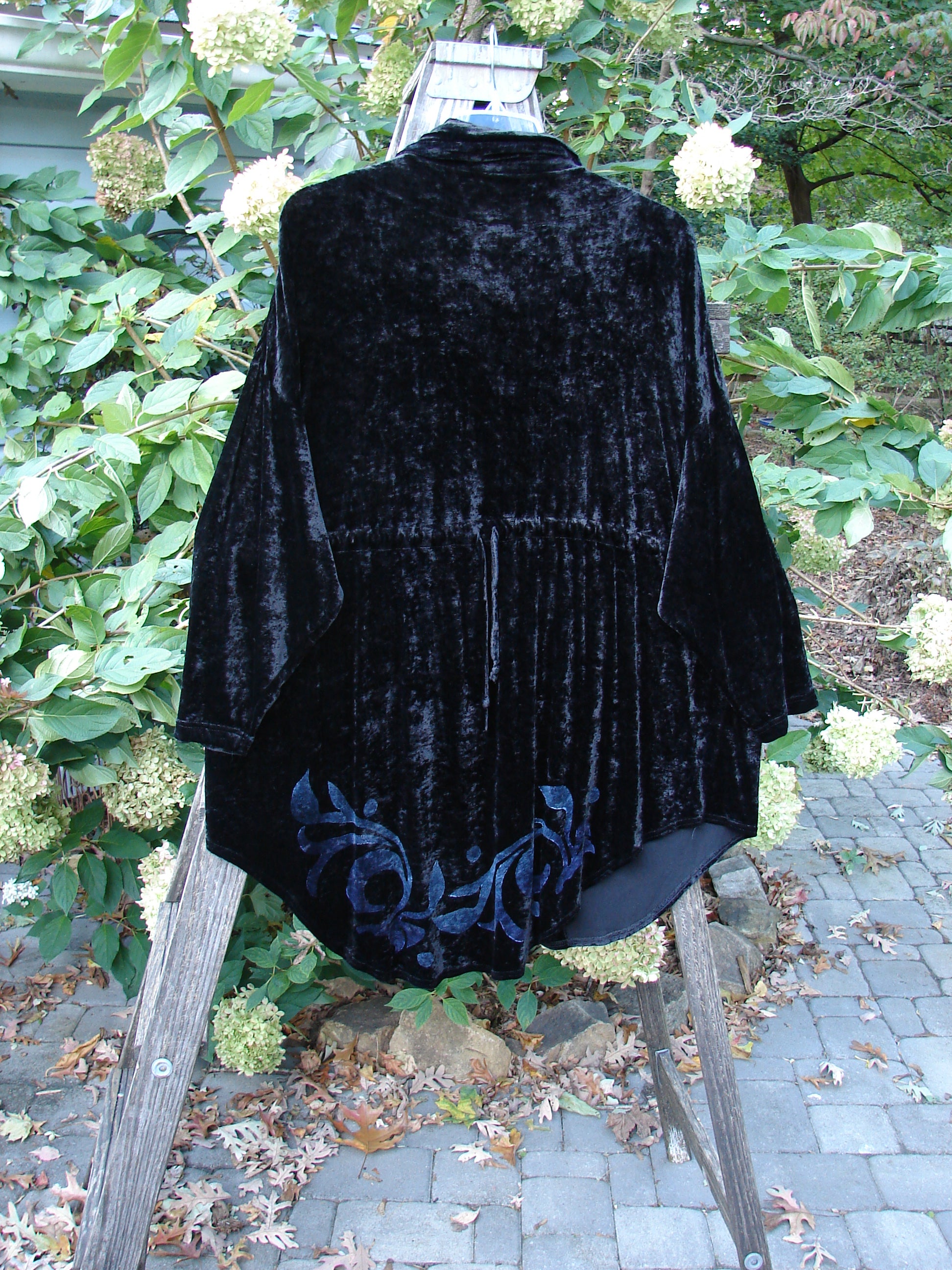 1997 Velvet Avatar Jacket Turn Moon Glow Obsidian Size 3 displayed on a stand, showcasing its collared neckline, oversized textured buttons, and unique hemline design, part of the vintage Blue Fish collection.