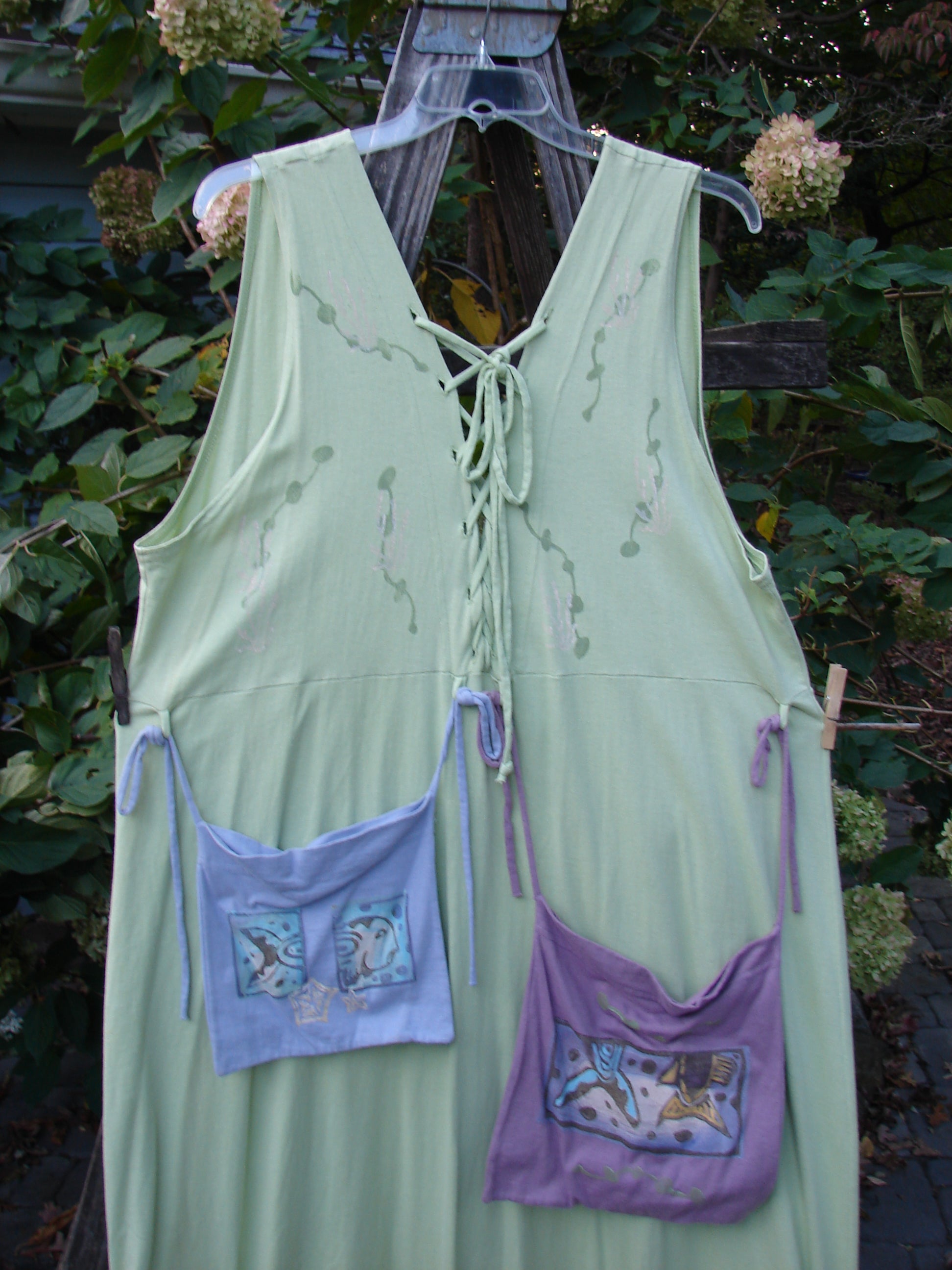 1997 Salt Water Taffy Jumper Sea Life Mellon Size 2 draped on a wooden fence, showcasing its pockets and textured buttons, reflecting vintage Blue Fish Clothing's eclectic style.