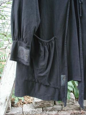 2000 Crepe Rennai Jacket Celtic Black Size 2: A close-up of a black robe with unique front and back ties, pointed hem accent, and gathered cuffs.