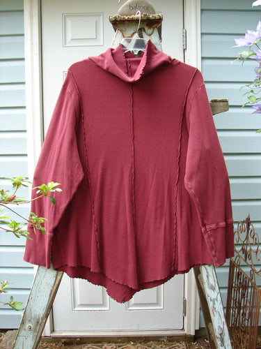 A burgundy Barclay Thermal Reverse Stitch Tunnel Pocket Top, size 2, with a floppy turtleneck and a kangaroo tunnel pocket. Features exterior stitched vertical sectional seams and a unique cut. Bust 54, waist 50, hips 52. Lengths: front/back 36, sides 30.