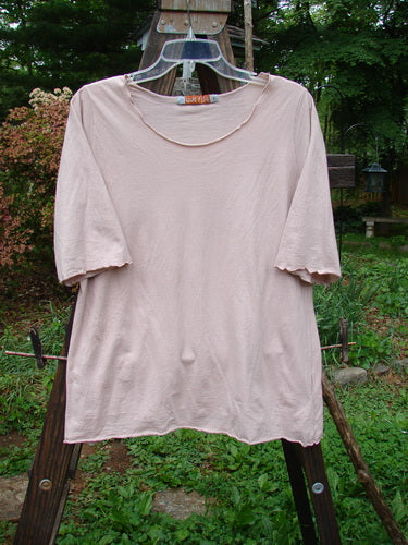 Barclay Batiste Curl Edge Layering Top Unpainted Pastel Mauve Size 1: A close-up of a pink shirt with curly edges, perfect for layering.