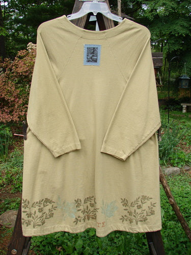 1998 Botanicals Bell Flower Top Plante Stem Size 1: A long sleeved beige shirt on a clothes line, made from organic cotton. Lovely belled A-line shape with a softly rounded neckline. Blue Fish signature patch on the back. Bust 50, Waist 54, Hips 60.