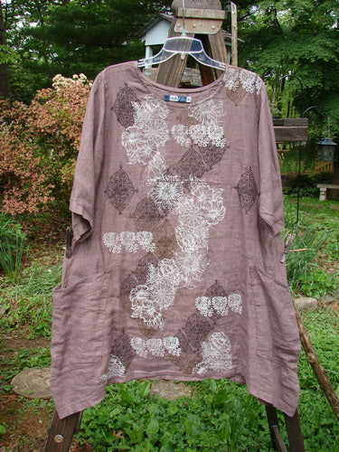 Barclay Linen Urchin Dress with continuous floral pattern in Twig. Medium weight linen. Rounded neckline, sway lower hemline, empire waist seam, wider sleeves, A-line flair. Front side pockets. Size 0. Bust 48, waist 50, hips 56. Length 34 front, 40 sides.