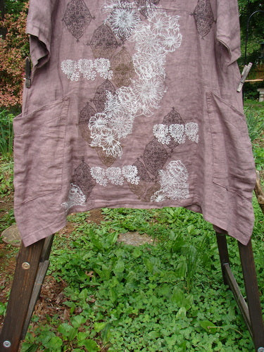 Image alt text: Barclay Linen Urchin Dress on clothesline with wooden post in background