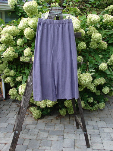 Barclay Linen Double Button Back Vent Skirt Unpainted Iris Size 2: A unique skirt with double button vents and a rear kick vent, made from mid-weight linen. Features a full elastic waistline and a lower widening shape.