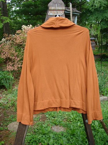 Barclay Fleece Two Button Jacket Vinery Gourd Size 1: A jacket on a wooden rack with dolman sleeves and a stand-up collar.