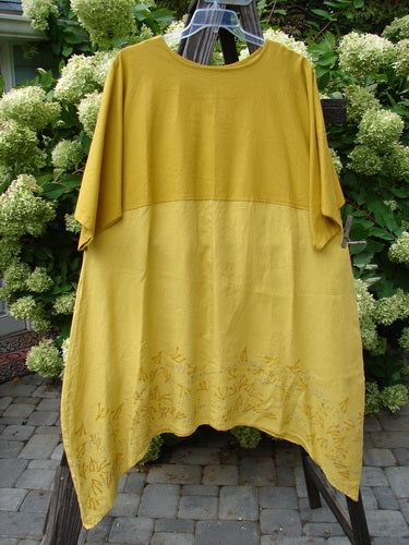 A Barclay Linen Figure 8 Empire Dress in Sunrise, size 2. Features include a rounded neckline, empire waist seam, and three-quarter length sleeves. The dress has a varying hemline with rain twig theme paint. Bust: 54, Waist: 58, Hips: 66. Front Back Length: 38, Sides: 47.
