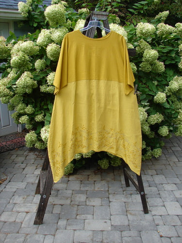 A yellow Barclay Linen Figure 8 Empire Dress with a swaying hemline and empire waist seam. Size 2.