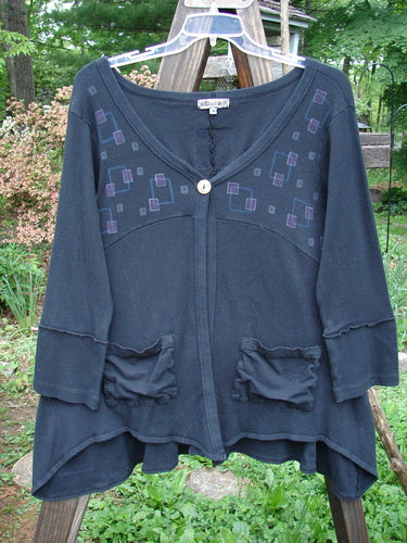 Barclay Patched Thermal Single Button Cardigan Tiny Square Black Size 0: A blue shirt with a patchwork design of tiny squares, featuring a single button closure, curved stitchery, drop front pockets, and a V-shaped neckline.