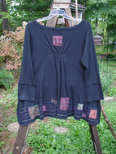 Image alt text: Barclay Patched Thermal Single Button Cardigan, black, with wooden rack in background.