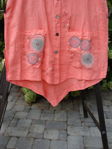 A pink Barclay Linen Katy Vest with a circle spin design, size 2. Features include thick pearly buttons, drop pockets, and a unique revers rear upper waist seam. Bust 52, Waist 56, Hips 58, Front Length 37, Back Length 46.