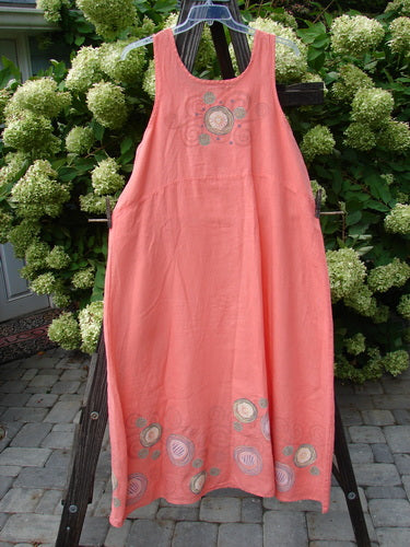 A Barclay Linen A Line Shift Dress in Tangerine, featuring a rounded neckline, downward curved empire waist seam, and a fully sweeping lower skirt. This dress is painted in the Circle Spin theme. Bust 48, Waist 50, Hips 58, Length 54, Hem Circumference 90.