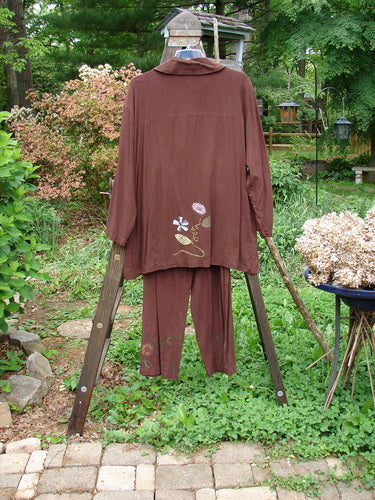 Barclay Tencel Collar Drawstring Studio Duo Spin Flower Sepia Size 1: A brown shirt and pants on a wooden stand, featuring a flower design.