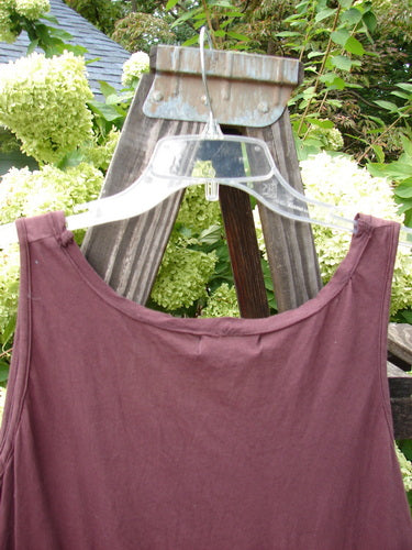 Alt text: Barclay NWT Batiste Decora Tiny Tank Unpainted Bordeaux Size 2: Close-up of a purple shirt with a flower on a swinger.