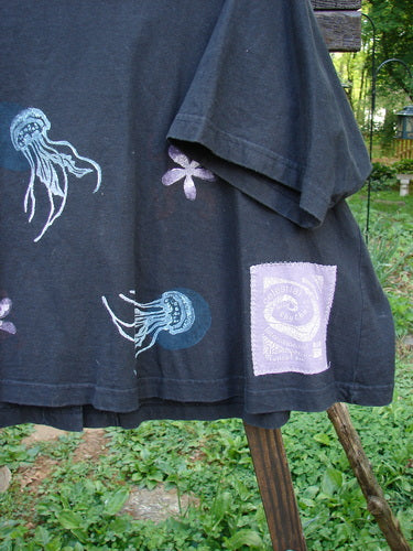 1997 Cove Jacket Sea Life Ebony Size 2: A black shirt with jellyfish design and porcelain closure. Flared A-line shape, V-neckline, swing style, and painted pockets.