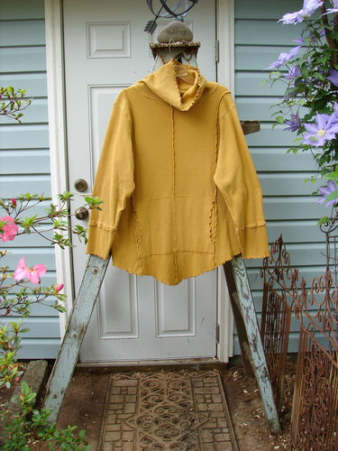 Barclay Thermal Reverse Stitch Tunnel Pocket Top Unpainted Mustard Size 1: A yellow jacket on a ladder, showcasing a unique cut with changes in just the right places.