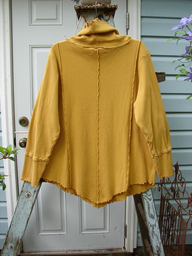 A yellow Barclay Thermal Reverse Stitch Tunnel Pocket Top with a curly turtleneck and a kangaroo pocket. Exterior stitched seams and a unique cut create a beautiful drape and sway. Size 1.