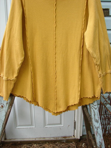 Barclay Thermal Reverse Stitch Tunnel Pocket Top Unpainted Mustard Size 1: A yellow shirt with a curly cowl neck and a kangaroo tunnel pocket.