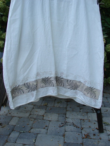 Barclay Linen Cotton Sleeve Banded Hem Pleat Dress Curl Fern White Size 2: A white towel with a design on it, hanging on a rack outdoors.