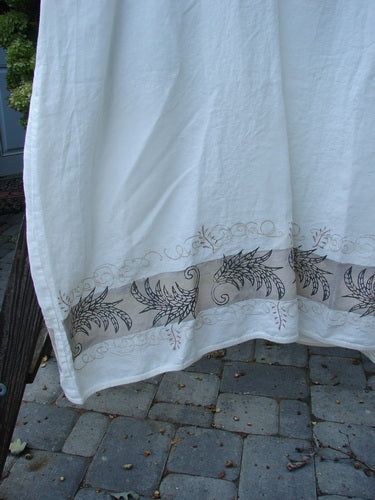 A white towel with a design on it, featuring black wings and a fern theme paint. Barclay Linen Cotton Sleeve Banded Hem Pleat Dress Curl Fern White Size 2.