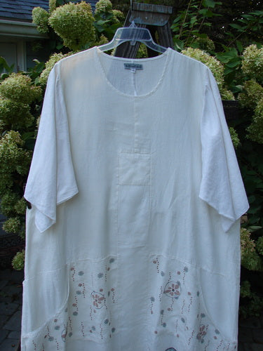 Image alt text: Barclay Linen Farmer Jen Dress with Daisy Day Theme Paint, featuring a white shirt with floral design and three-quarter length sleeves.