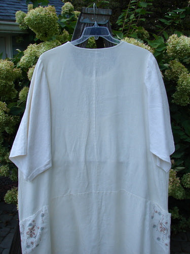 Image alt text: Barclay Linen Farmer Jen Dress Daisy Days Natural Size 2 - White shirt on a swinger, medium weight linen, three-quarter length sleeves, A-line flair, and paneled lower hem.