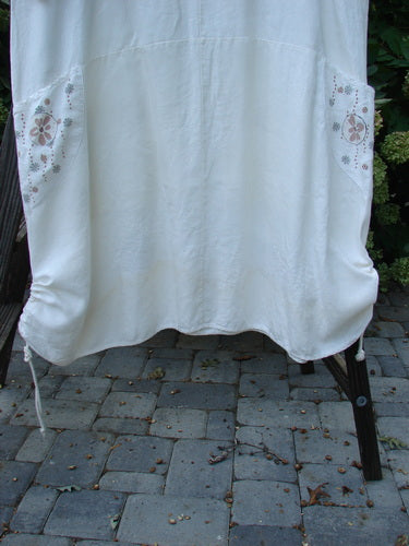 Image alt text: Barclay Linen Farmer Jen Dress Daisy Days Natural Size 2, a white sheet on a rack, outdoor textile cloth towel