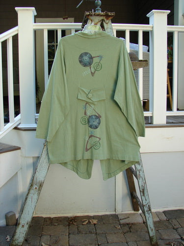 1996 Boulevard Jacket Giant Pinwheel Spanish Moss Size 0: Green jacket on a ladder, with a unique design and interesting features like a button-accented cut collar, button-tabbed back, and varying shirttail hemline. Perfect for Blue Fish collectors!