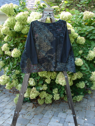 A Barclay Cotton Lycra Treesoul Top with a wide square flair and a boatneck rolled neckline, featuring a continuous royal metallic theme art on the front.