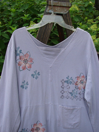 Image alt text: 2000 4 Vent Top Daisy Grid Pale Purple Size 1 - A floral shirt with rippie buttons, unique vents, and a V-shaped neckline.