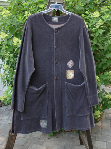 1999 Stretch Cord Patched Robe Jacket Dusk Forest Grey Plum Size 1: A long black coat with patch details, vented sides, and oversized buttons.