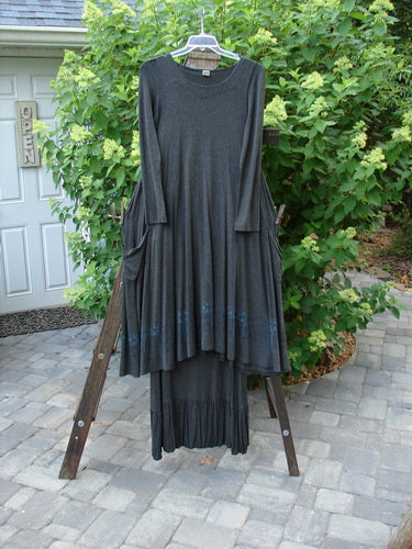 2000 Rayon Lycra Midi Bubble Trio Sparkle Border Charcoal Size 1 2: A dress on a rack with a unique fall and sway, scoop neckline, and A-line shape.